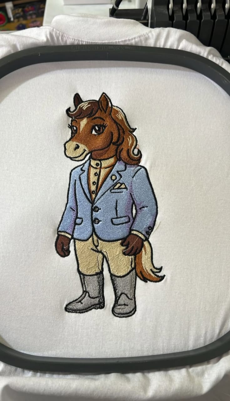Custom horse character front chest embroidery on white fabric with detailed jacket and clean stitch work